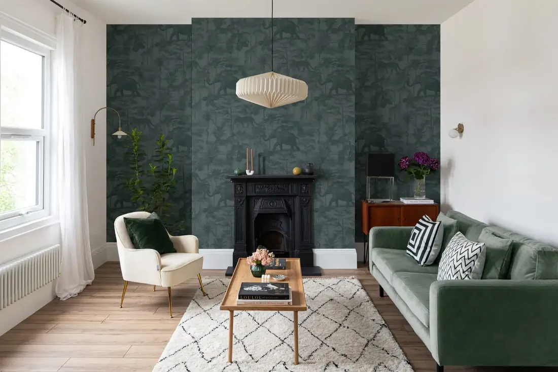 Living room with a deep green botanical wallpaper on the chimney breast and fireplace wall